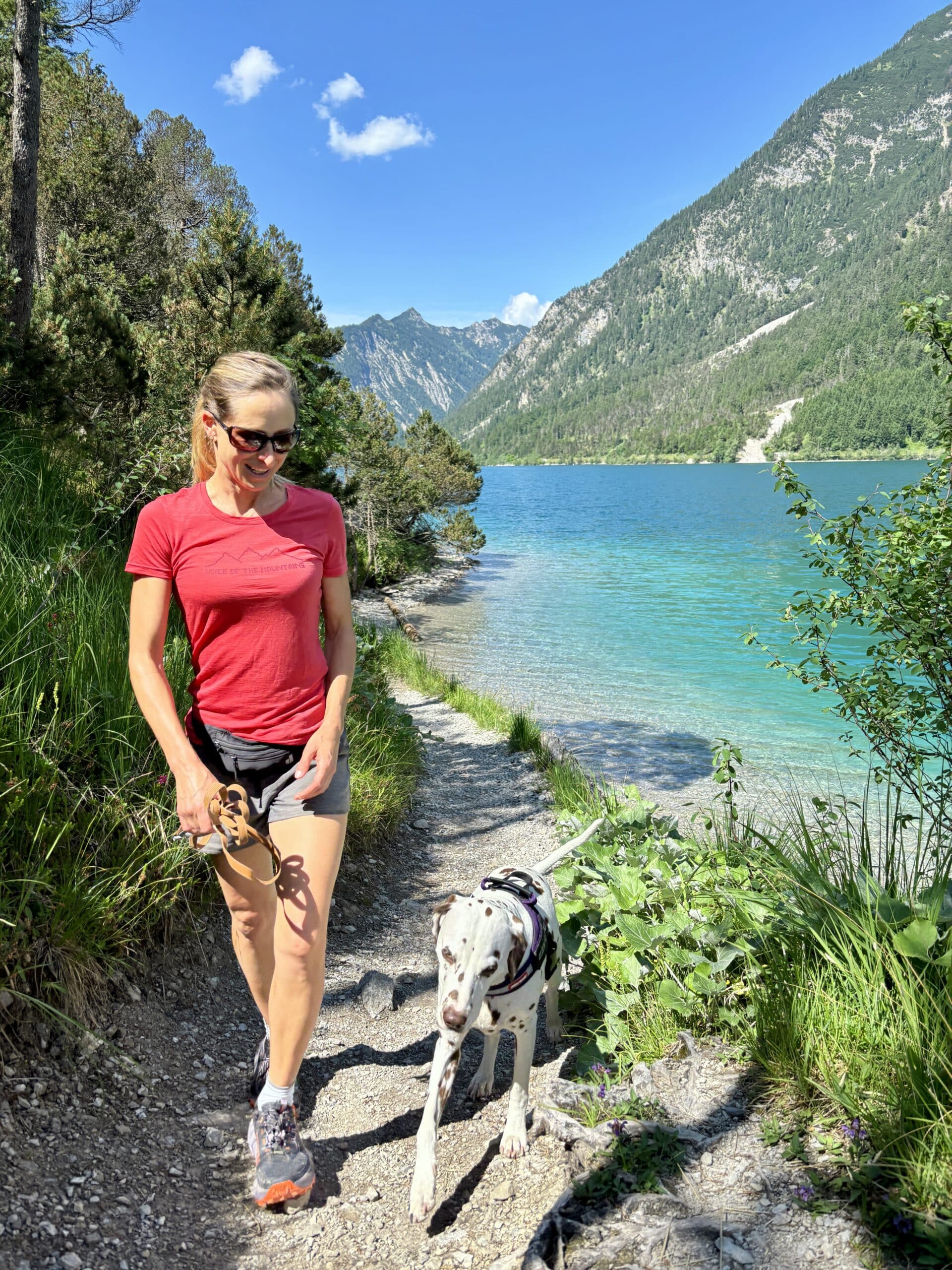 Plansee Rundweg mit Hund; Frau wandert mit Hund am Ufer