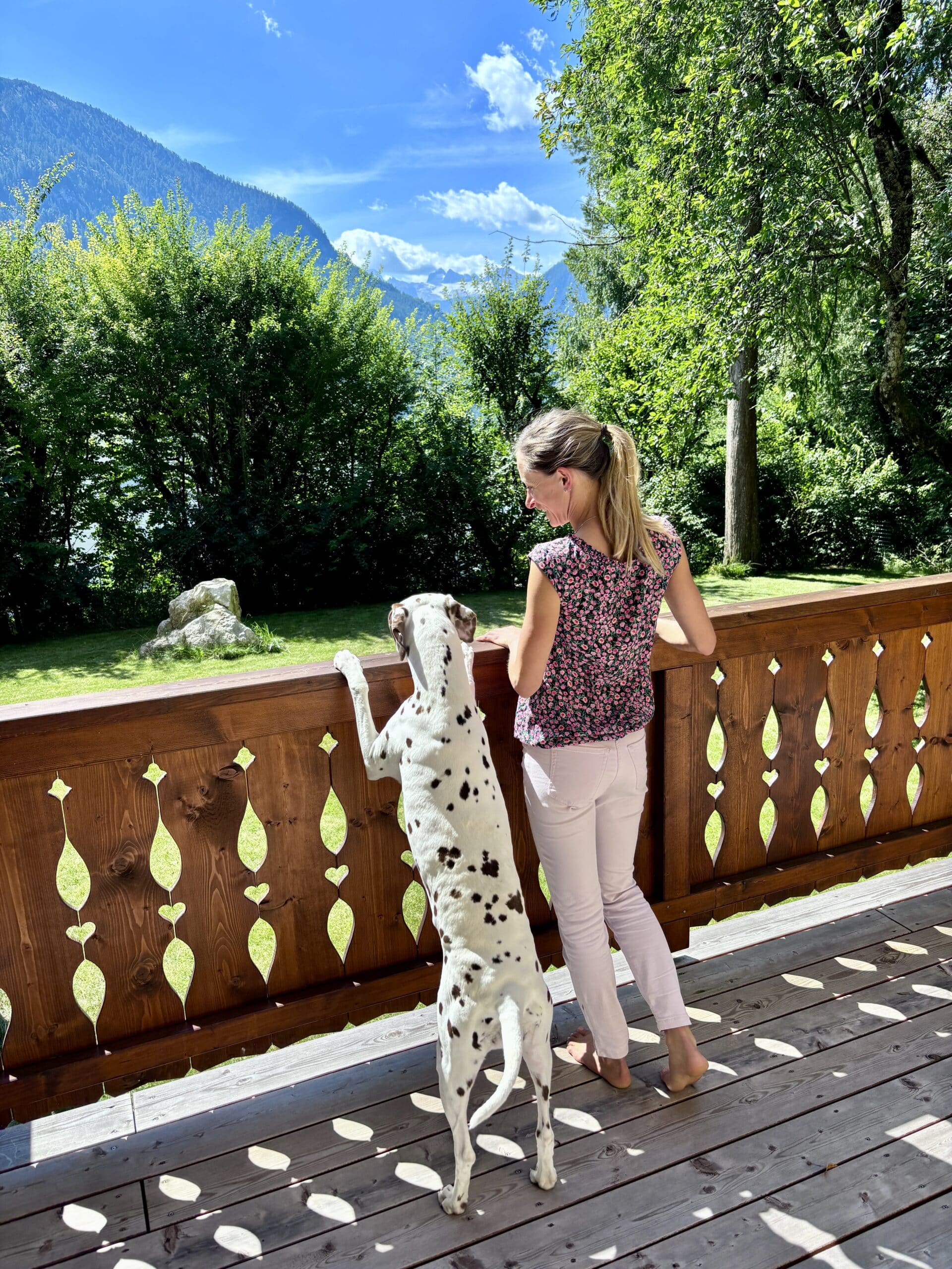 Terrasse und Garten Dachstein Residenzen; Frau mit Hund auf Terrasse;