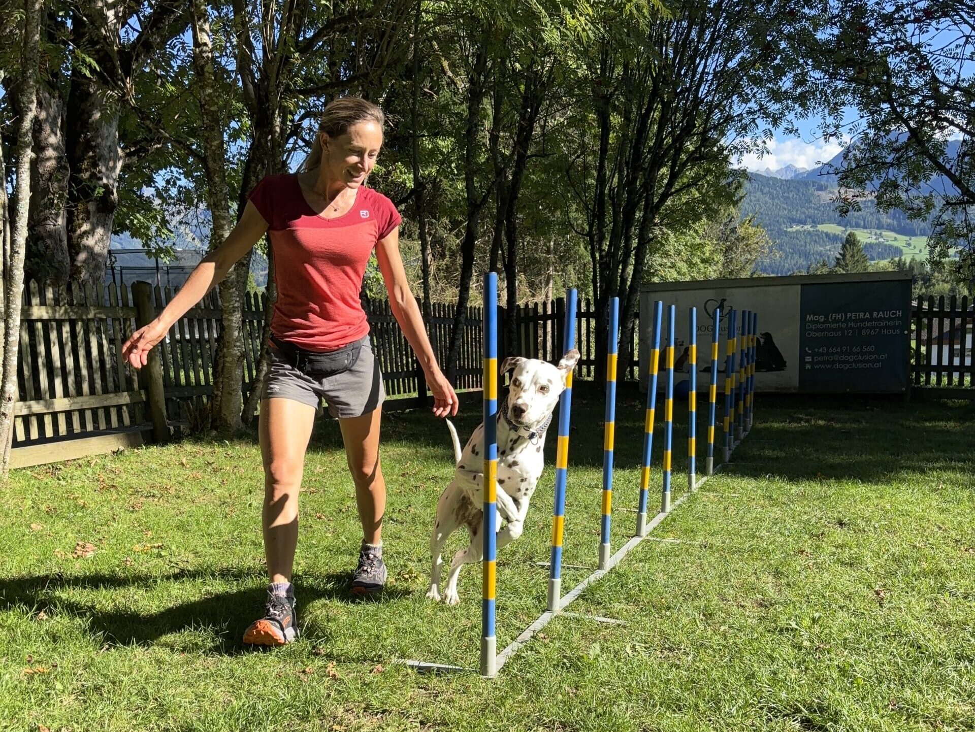 Slalom Agility Park; Frau trainiert mit Hund im Hotel Almfrieden